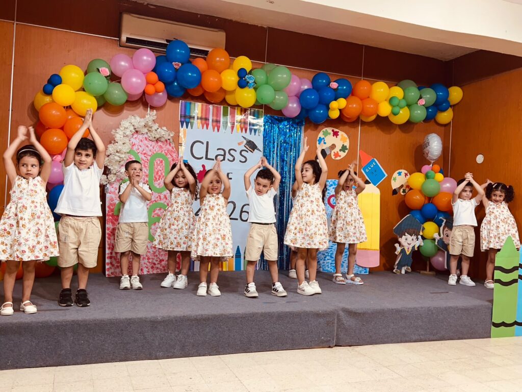 Young children in school on stage playing